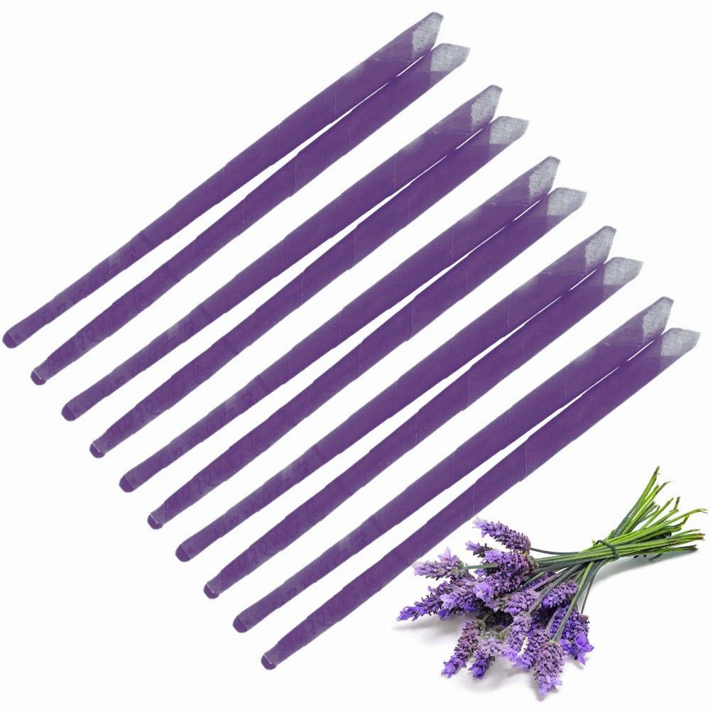 Two long, slender lavender-coloured ear candles resting on a neutral background.
