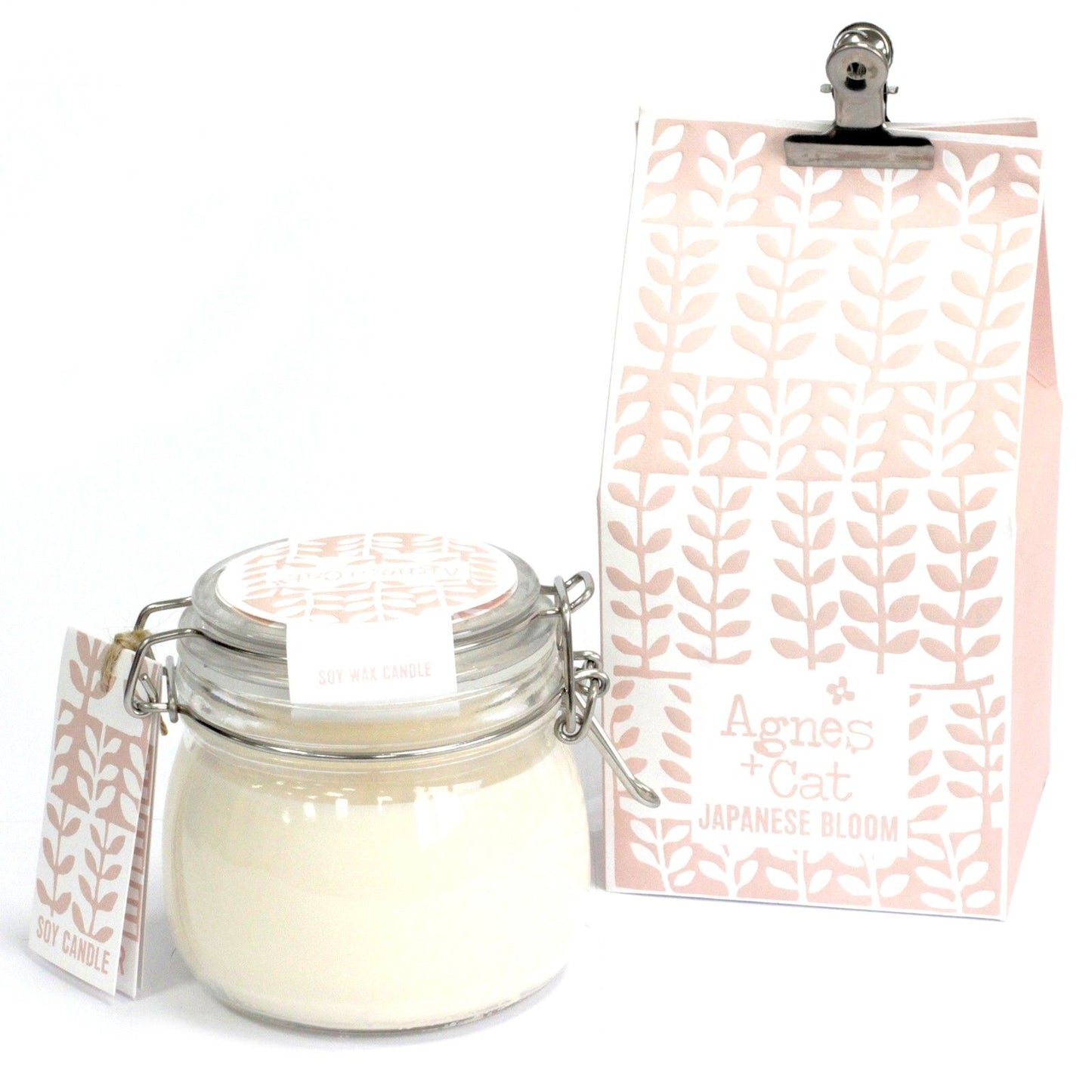 Clear glass Kilner jar candle filled with white soy wax and a single wick, featuring a simple floral label.