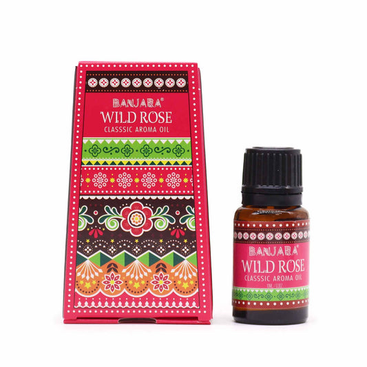 A small brown glass bottle of Wild Rose fragrance oil with a decorative label featuring pink roses.