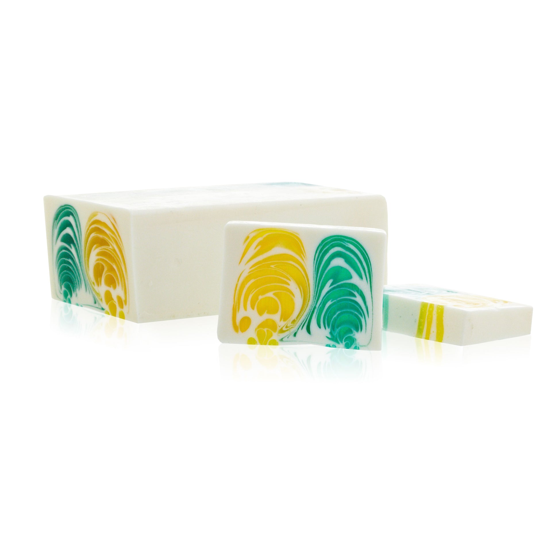 Large artisanal soap loaf with vibrant citrus colours and a textured surface for slicing.