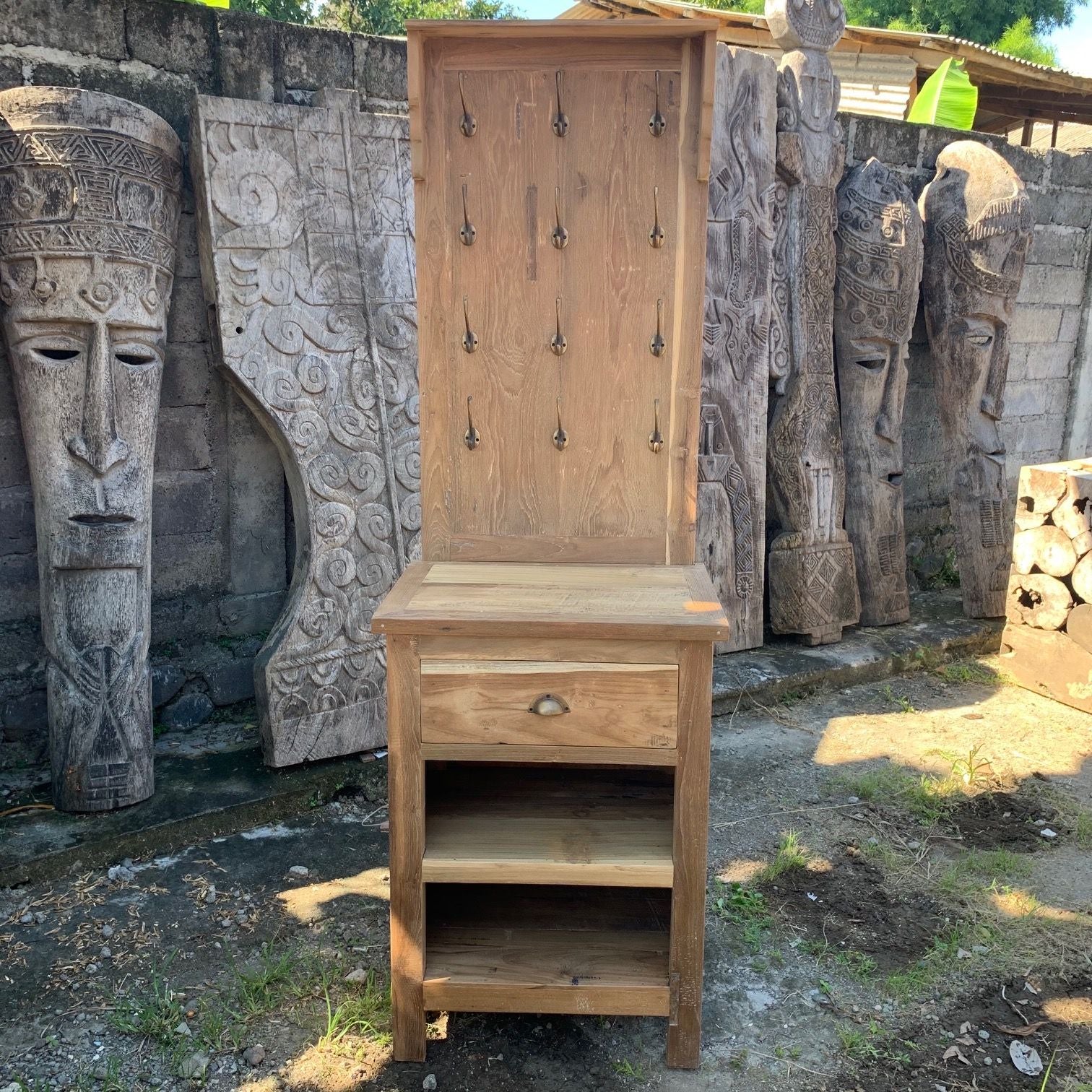 Rustic recycled wood display stand with multiple metal hooks and a small storage shelf for home decor.