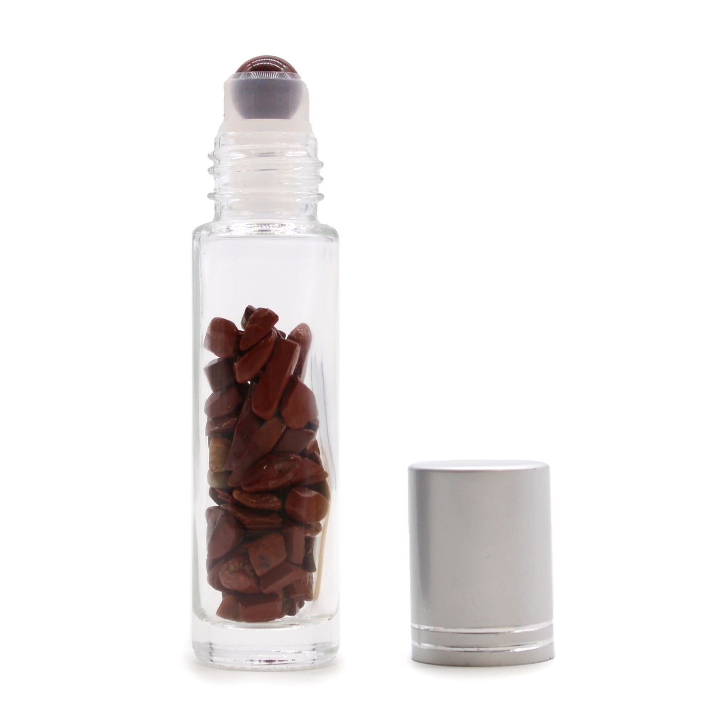 Clear glass essential oil roller bottle with small red jasper chips inside and a polished red jasper roller ball.