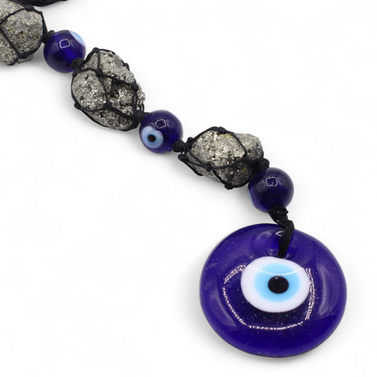 Handcrafted hanging pendant featuring sparkling natural pyrite stones, deep blue glass beads, and a protective evil eye charm