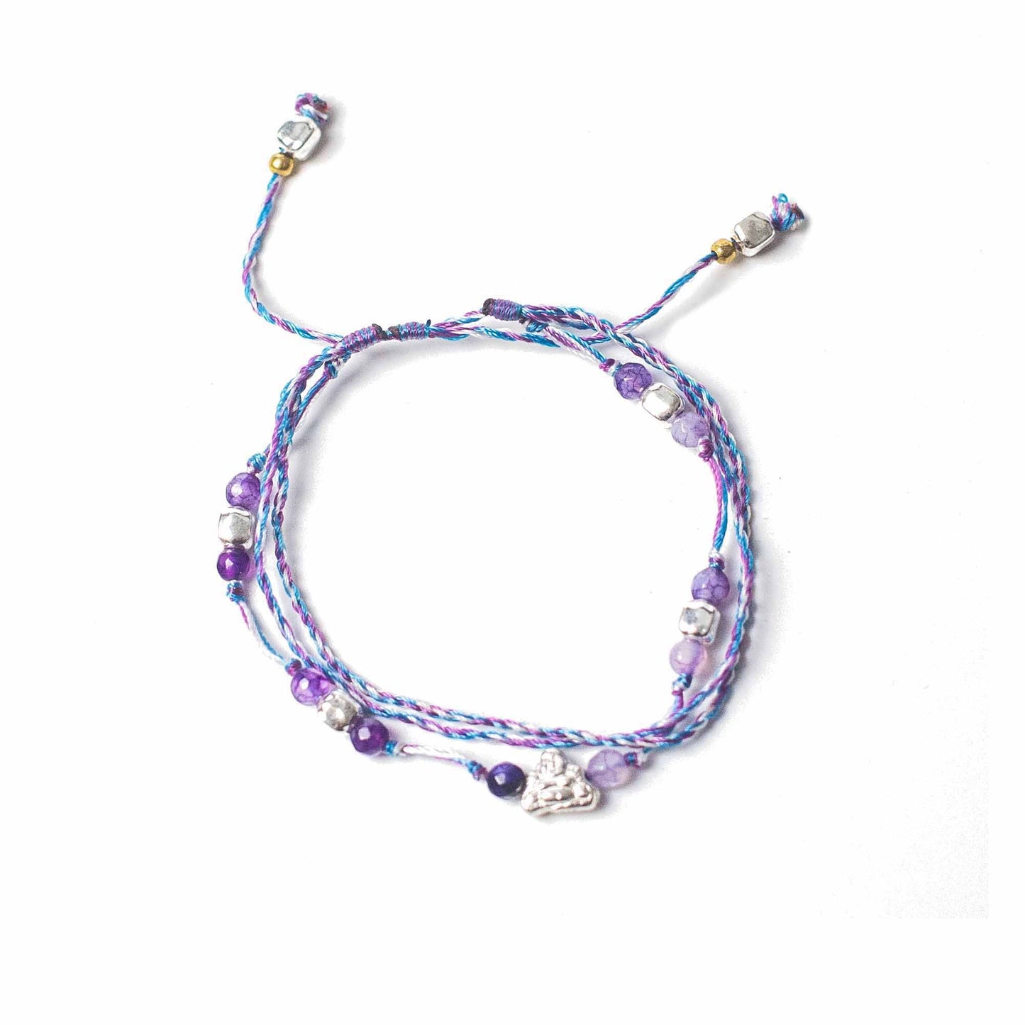 Close-up of a handcrafted colourful temple string bracelet featuring symbolic charms for protection and abundance.