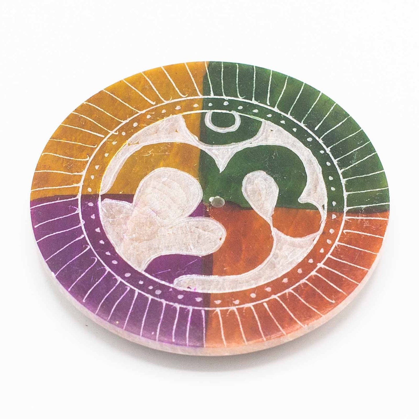 Circular grey soapstone incense burner with a carved Om symbol in the centre and small holes for incense sticks.