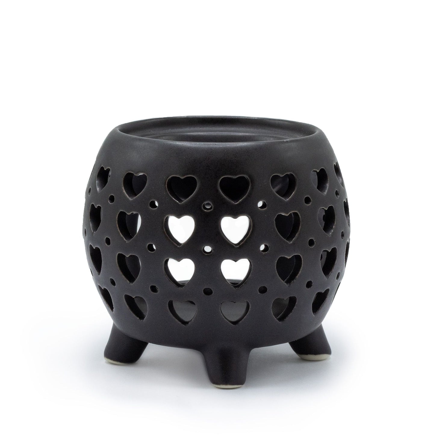 Contemporary squat pot ceramic oil burner in a matt black finish featuring a decorative multi heart cut-out design.