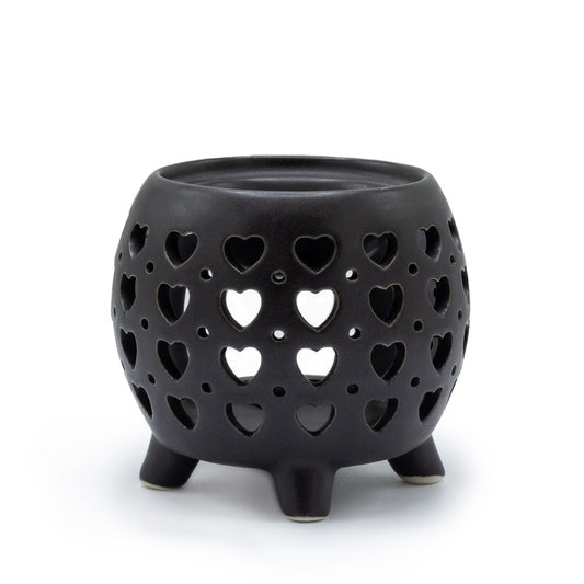 Contemporary squat pot ceramic oil burner in a matt black finish featuring a decorative multi heart cut-out design.