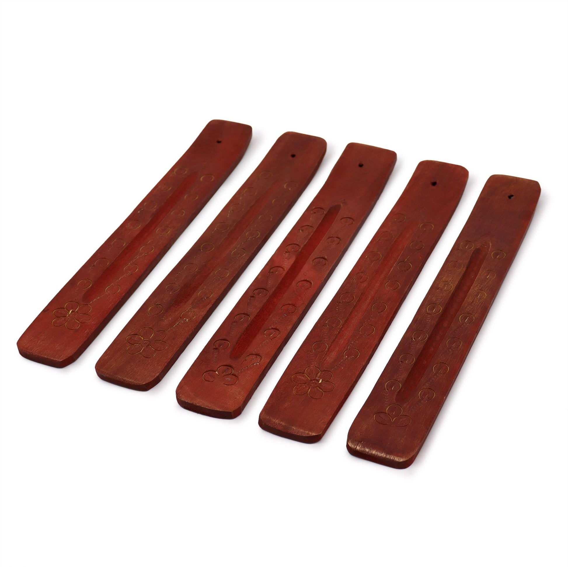 Long hand-carved mango wood incense ashcatcher with intricate patterns and a natural wood finish.