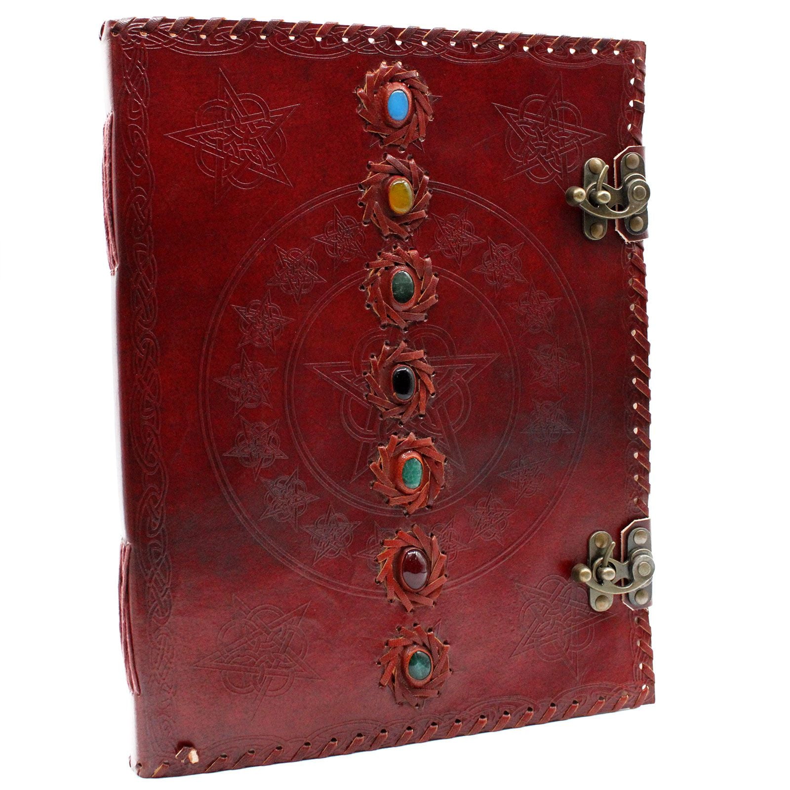 Large vintage style leather journal featuring seven embossed chakra symbols and decorative metal clasps on a dark cover.