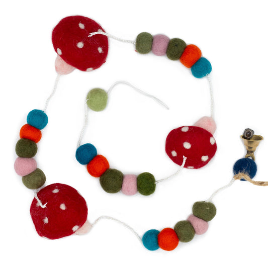 Handcrafted felt wall hanging featuring vibrant red and white spotted mushrooms on a neutral background.