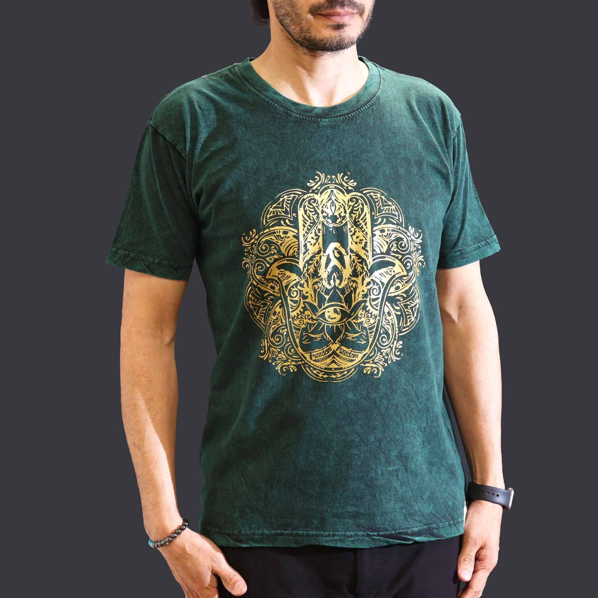 A green stone-washed t-shirt featuring a central Hamsa hand symbol in a relaxed nomadic style.