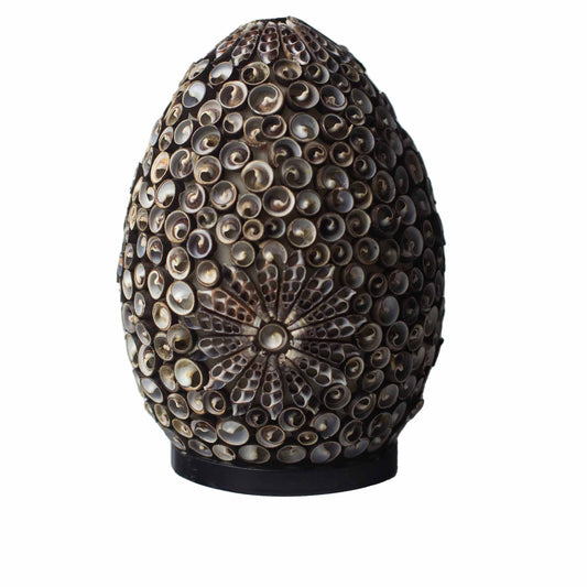 Handcrafted oval lamp featuring a spiral pattern of chocolate-toned sea shells on a black base.