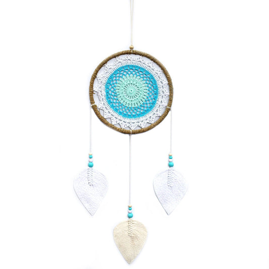 Large turquoise dream catcher with an intricate woven web and natural hanging elements without feathers.