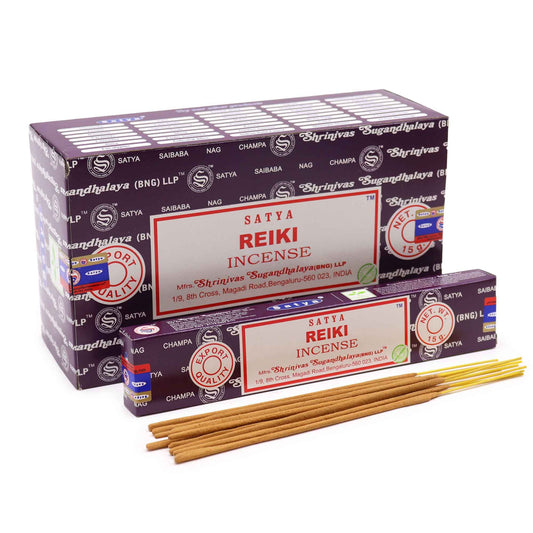 Hand-rolled incense sticks in a blue box with traditional patterns on a plain background.