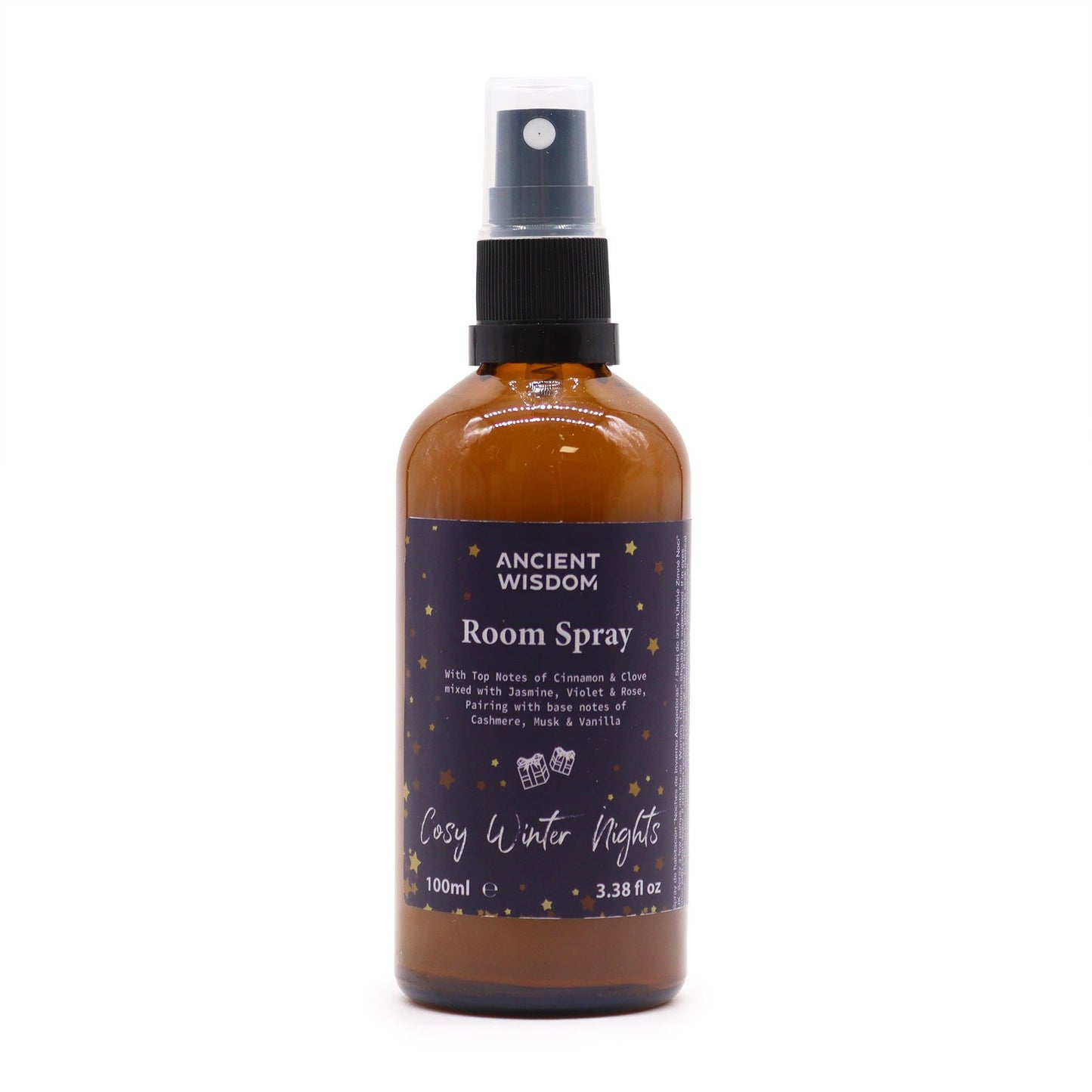 Amber glass bottle of room spray with a black spray nozzle on a neutral background.