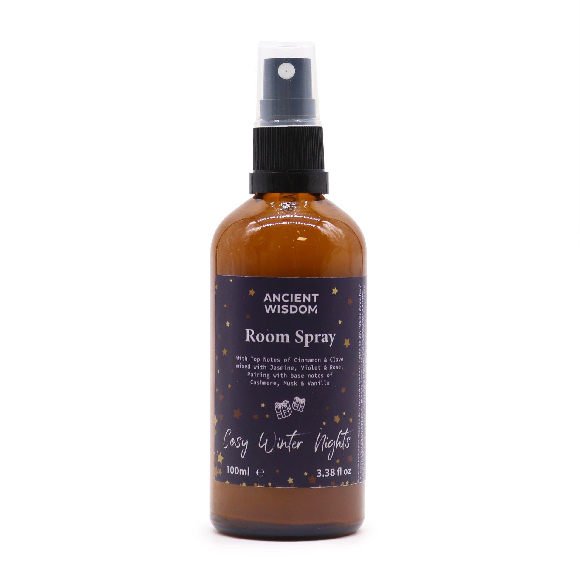 Amber glass bottle of room spray with a black spray nozzle on a neutral background.