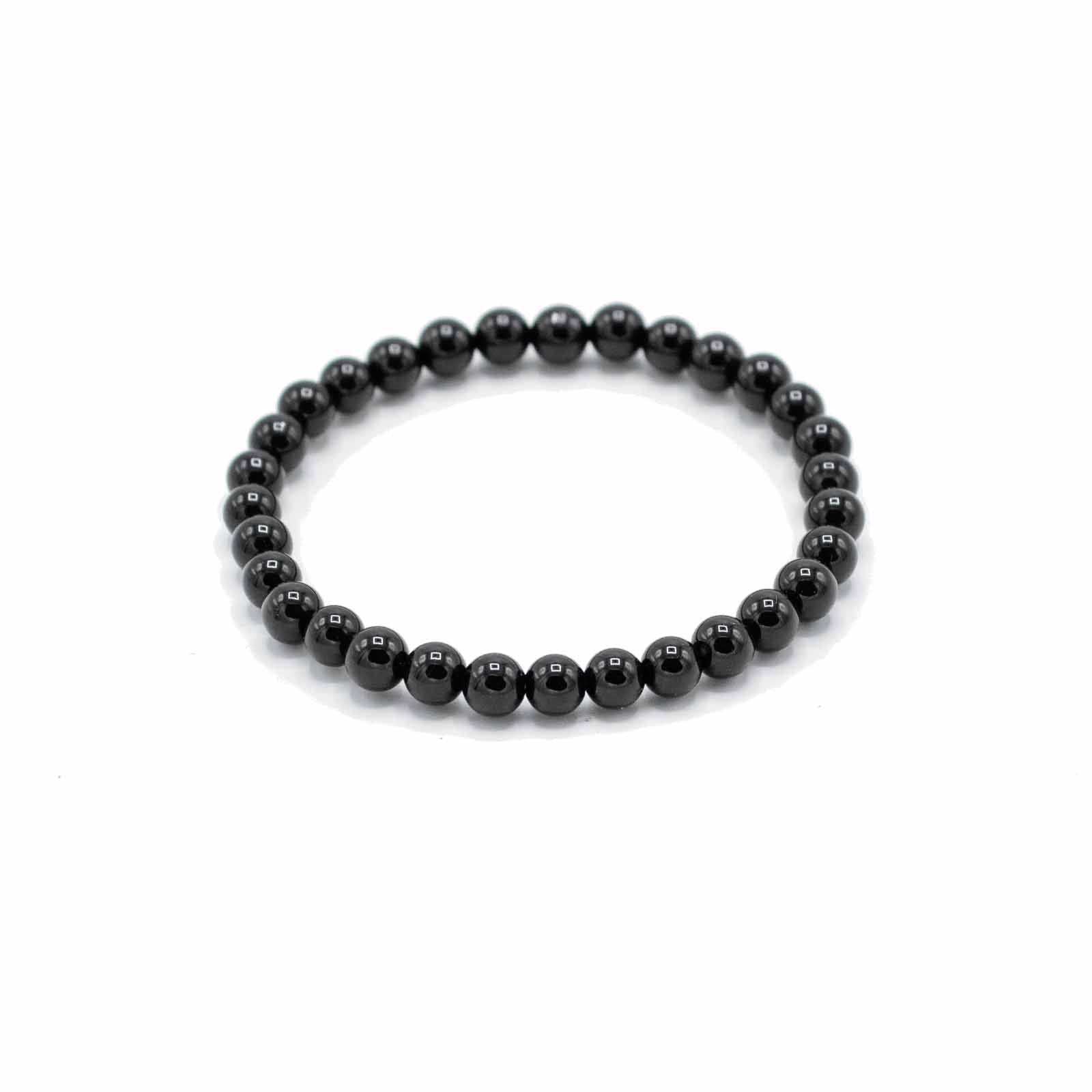 Handcrafted gemstone bracelet featuring smooth, polished black agate beads on an elasticated cord.