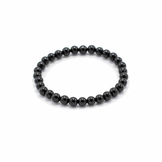 Handcrafted gemstone bracelet featuring smooth, polished black agate beads on an elasticated cord.