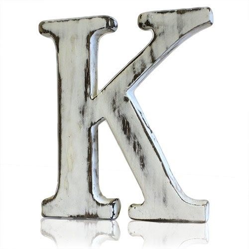 Hand-carved mango wood alphabet letter K with a rustic white-wash finish on a plain background.