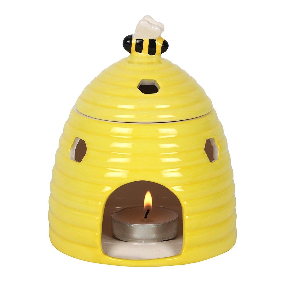 Charming yellow ceramic oil burner featuring a textured beehive design with small circular cut-outs.