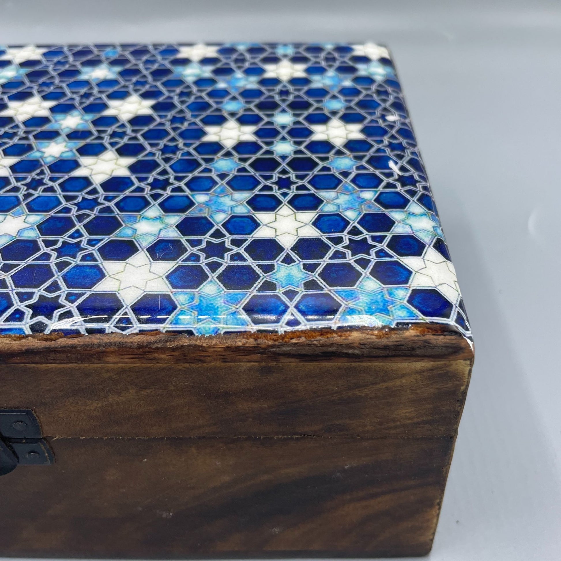 Large wooden keepsake box with a blue ceramic lid featuring white and yellow star patterns.