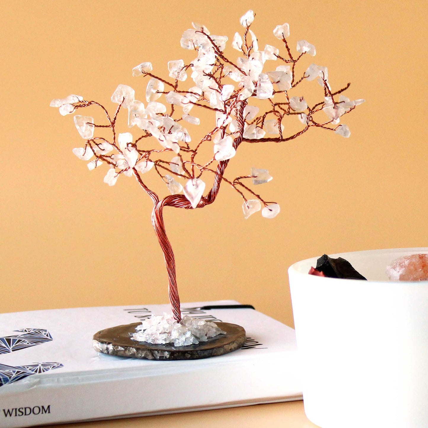 Large gemstone tree featuring clear rock quartz crystal leaves on a polished black agate base with twisted wire branches.