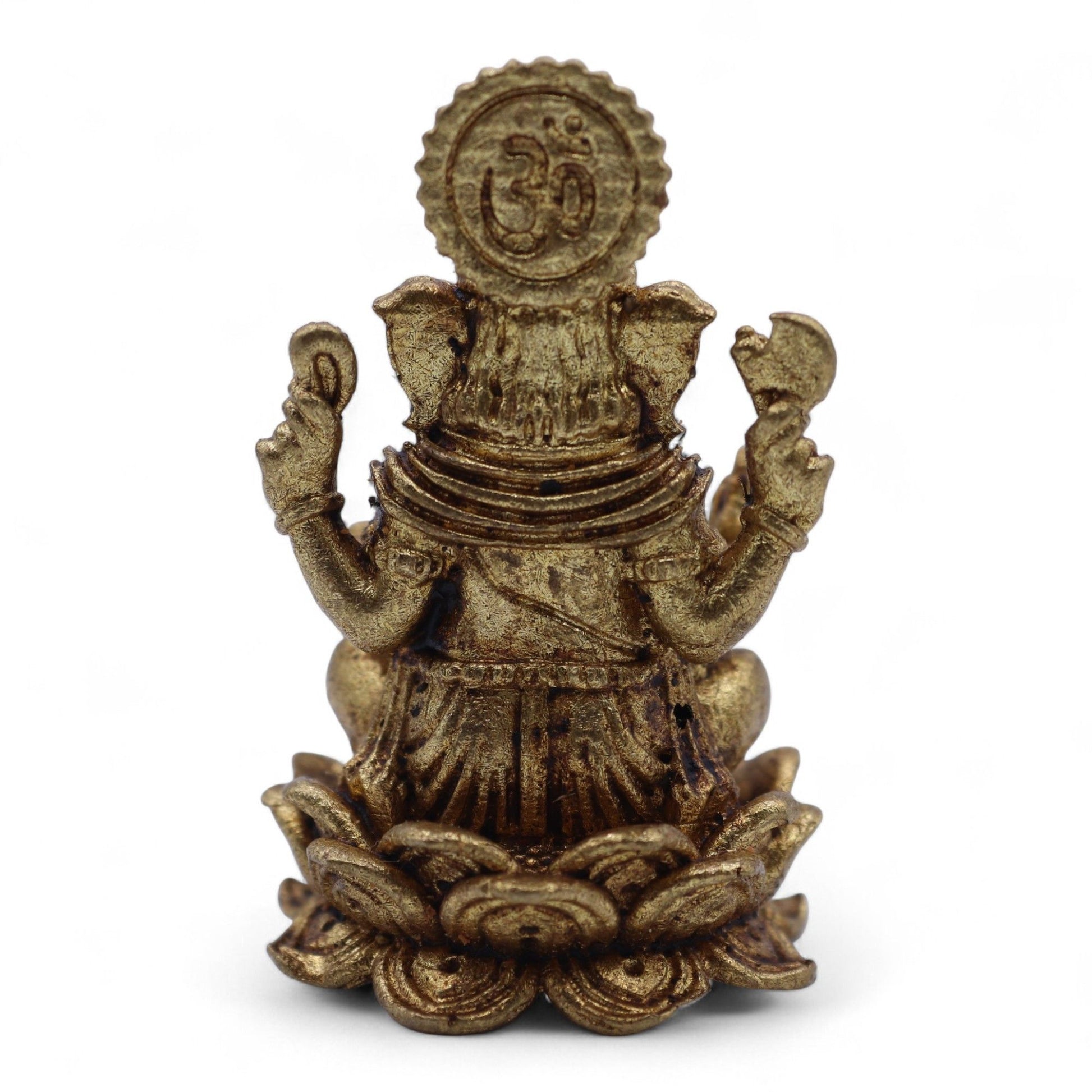 Detailed miniature brass Ganesha figurine seated on a lotus base, handcrafted with intricate traditional patterns.