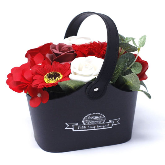 Petite wicker basket filled with realistic red soap roses and decorative greenery for a luxurious bath experience.