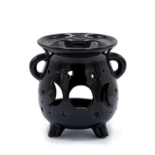 Matte black ceramic cauldron-shaped oil burner featuring carved moon phase cut-outs on the side.