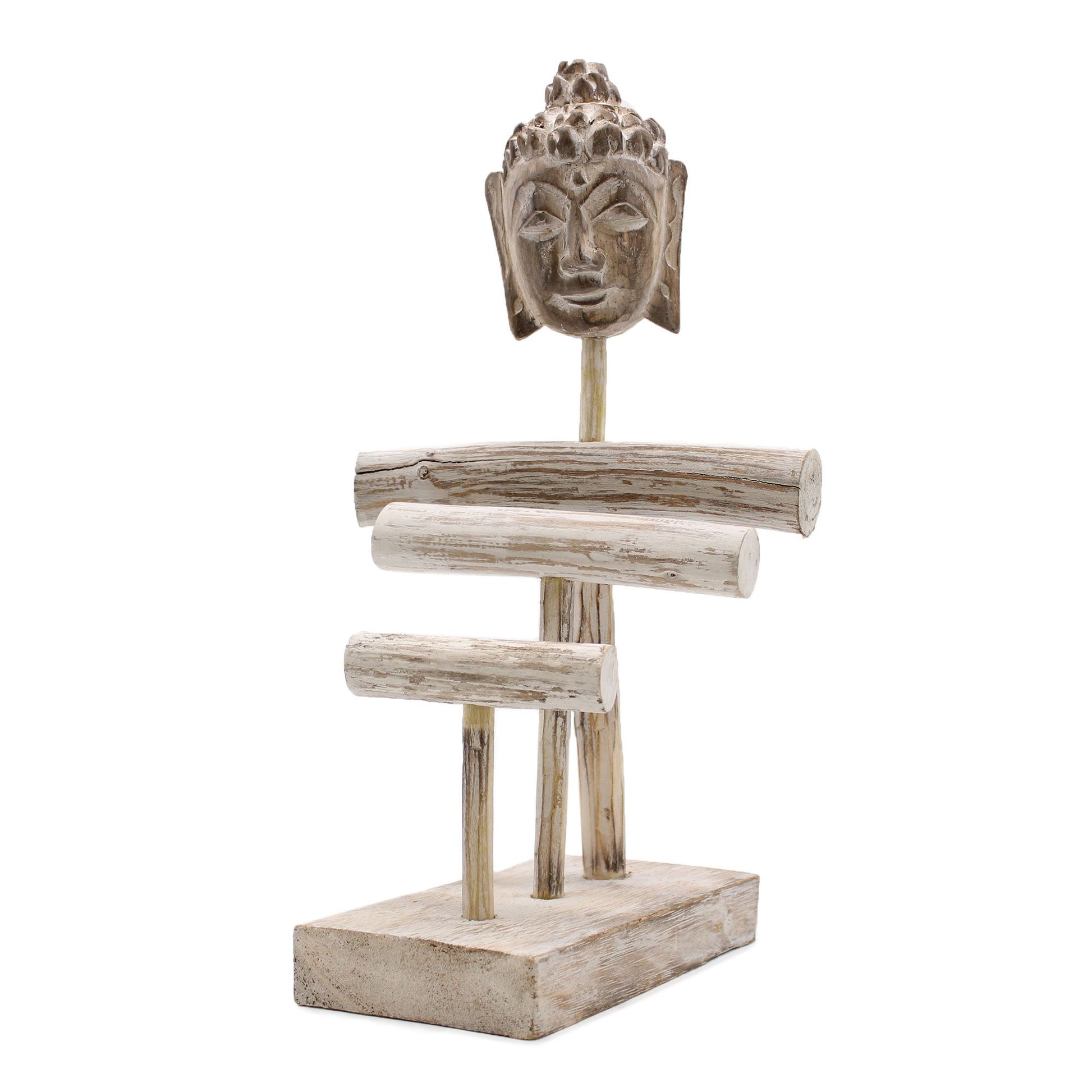 Carved wooden Buddha sitting beneath three decorative branches in a distressed whitewash finish.