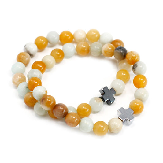 Two stretch gemstone bracelets featuring matte blue amazonite and speckled yellow jasper beads on a neutral background.
