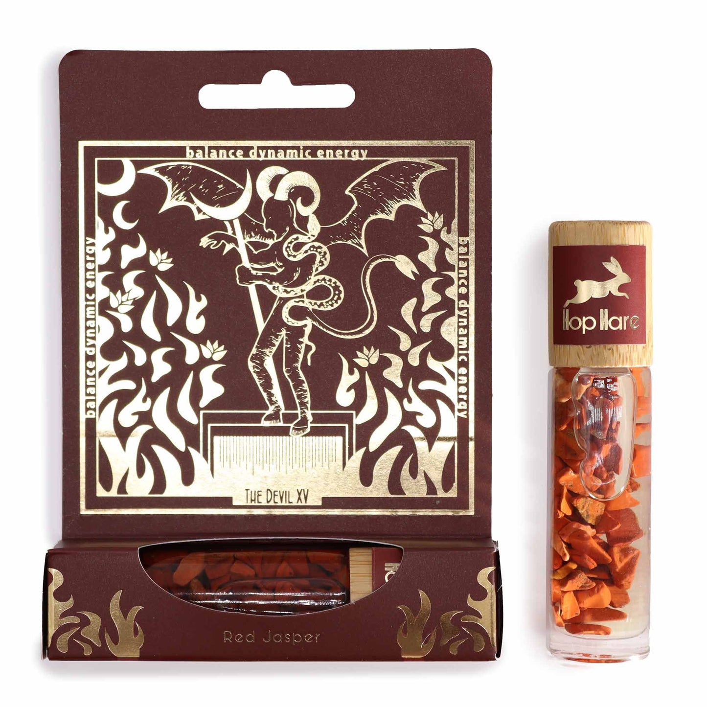 Gemstone-infused essential oil roll-on bottle featuring Red Jasper stones and tarot-inspired label art.