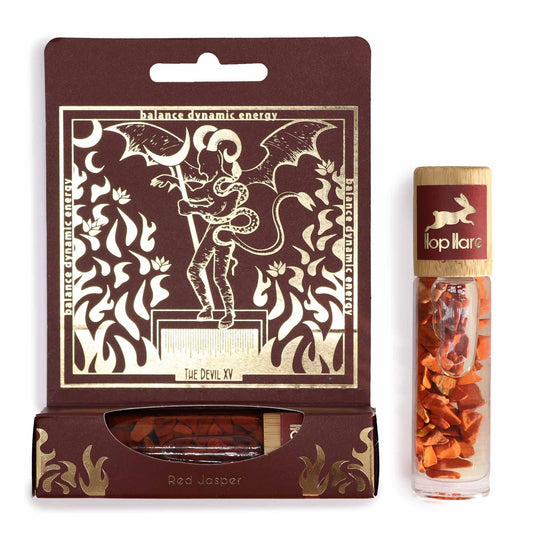Gemstone-infused essential oil roll-on bottle featuring Red Jasper stones and tarot-inspired label art.
