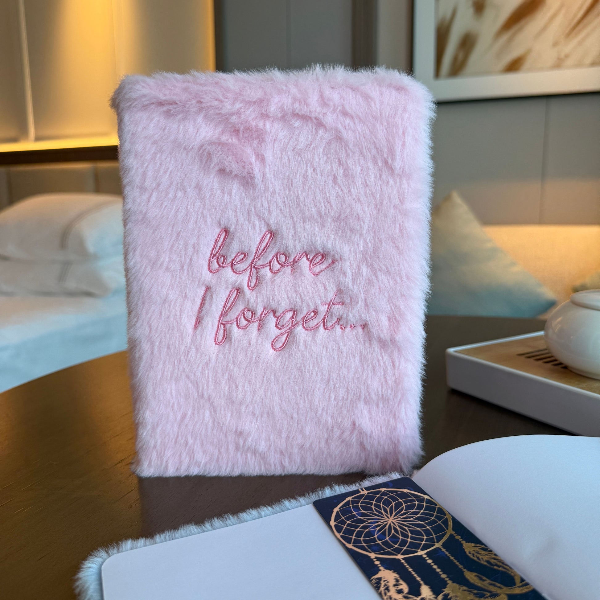 Soft pastel pink dream journal with a fluffy faux-fur cover and embroidered text reading before I forget.