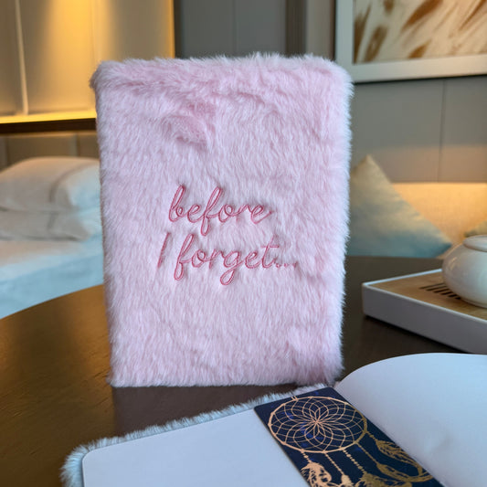 Soft pastel pink dream journal with a fluffy faux-fur cover and embroidered text reading before I forget.