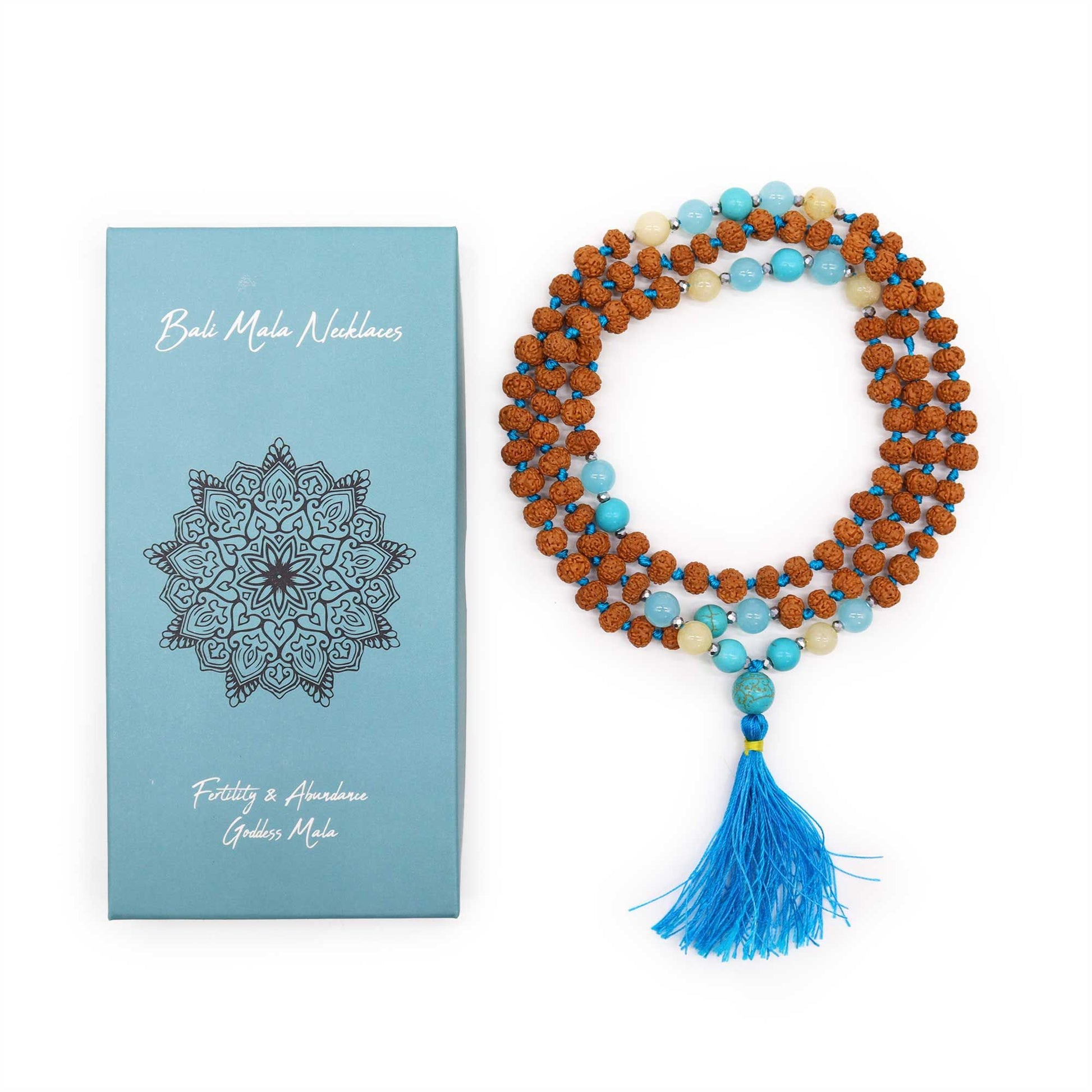Hand-knotted Bali Mala necklace with 108 Rudraksha beads, blue silk tassel, and silver accents on a blue background.