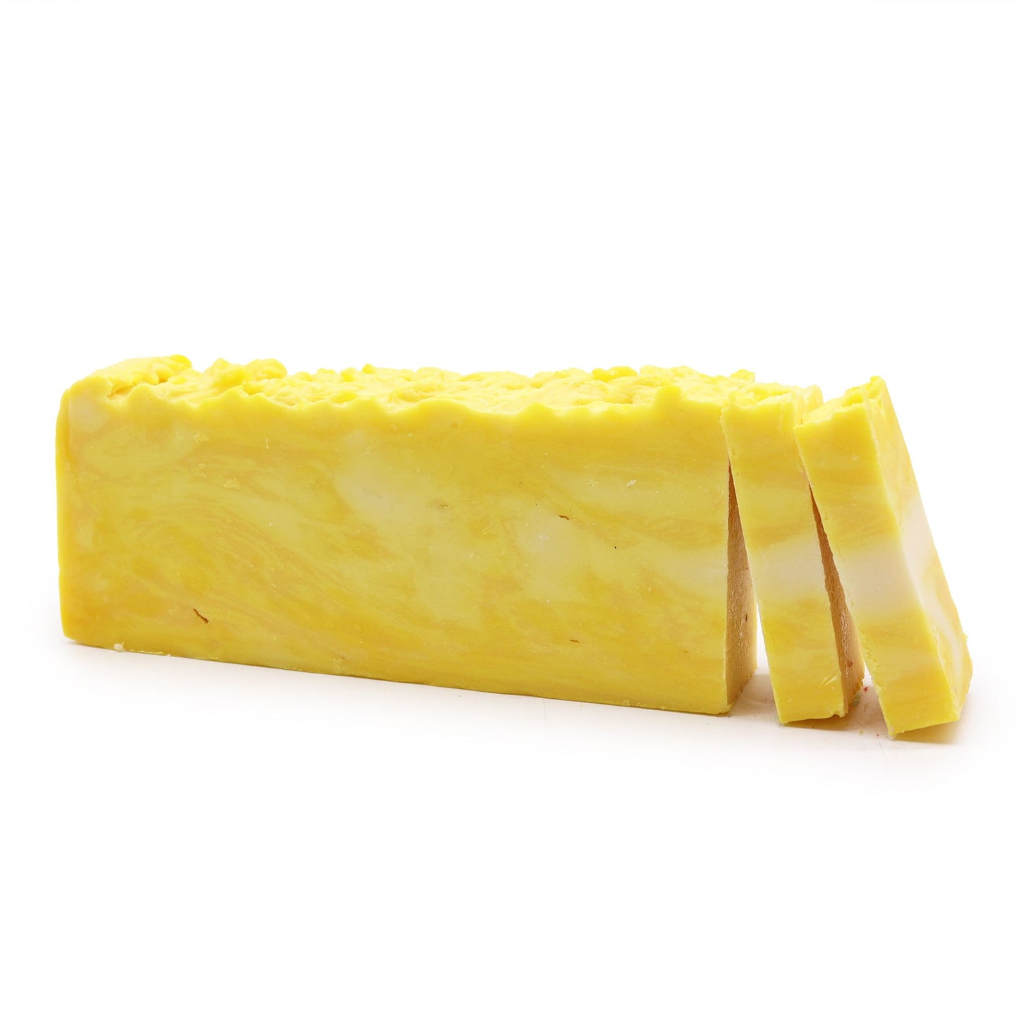 Handcrafted lemon olive oil soap loaf with a vibrant yellow colour and natural textured surface.