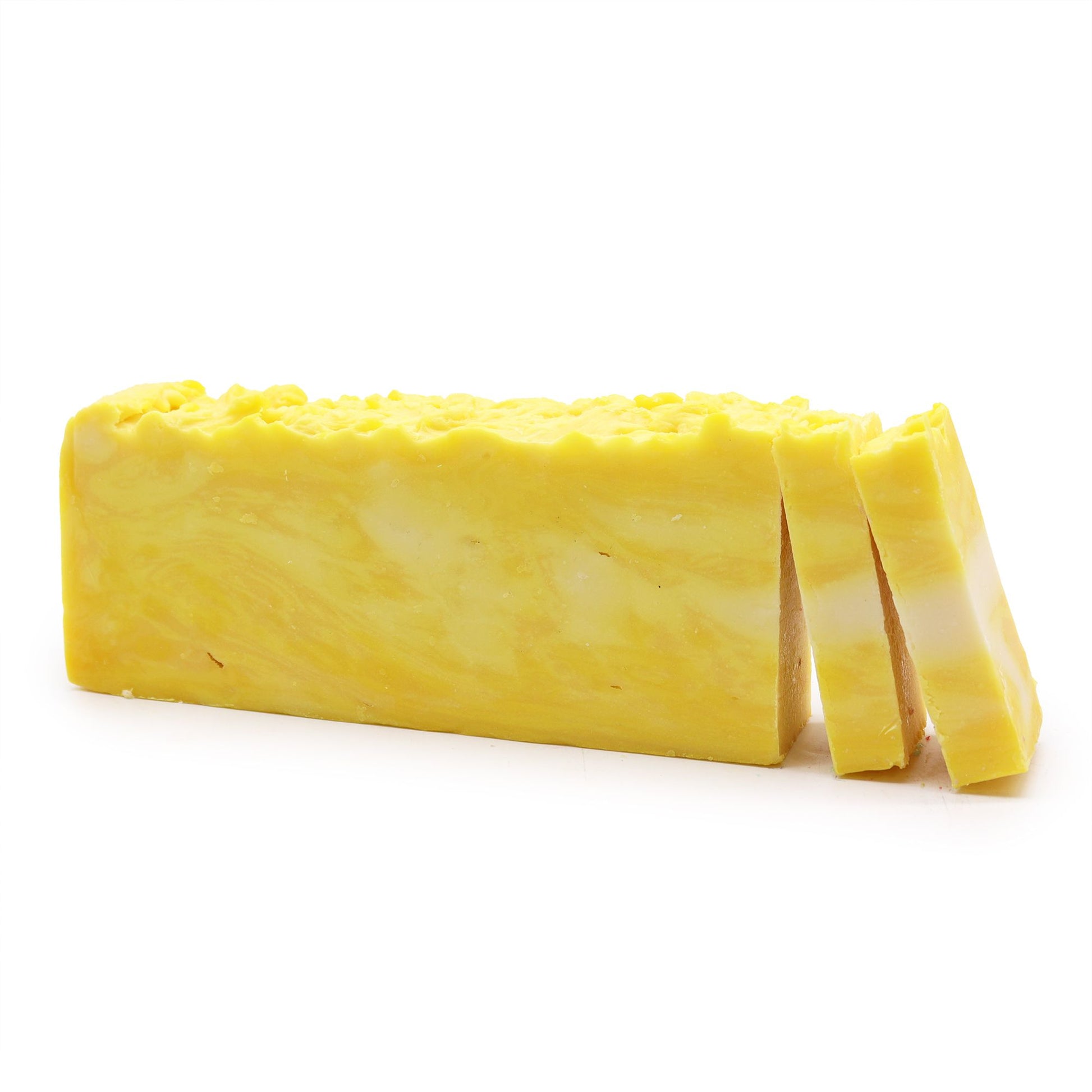Handcrafted lemon olive oil soap loaf with a vibrant yellow colour and natural textured surface.