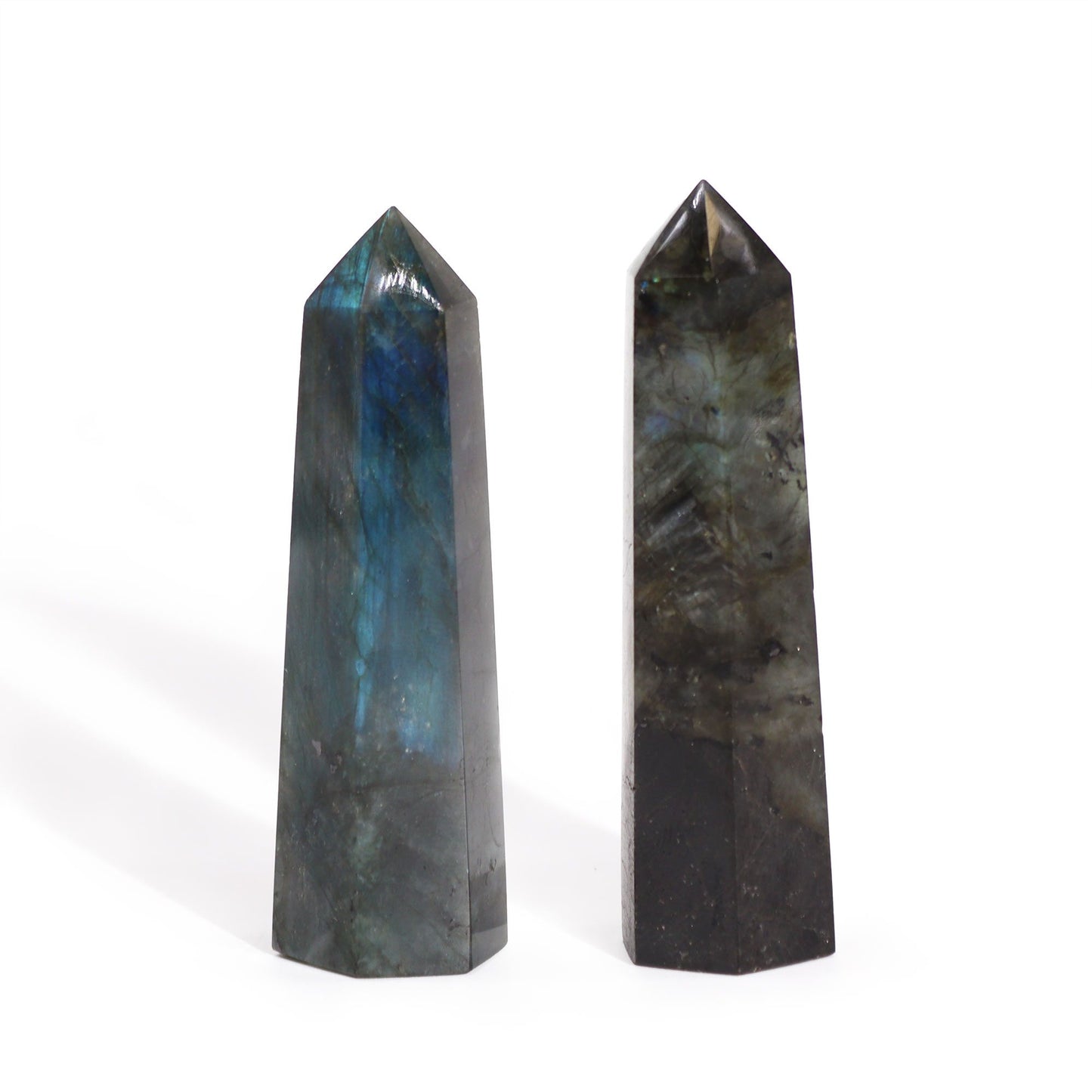 Sleek, polished Madagascar Labradorite crystal point showing shimmering iridescent blue and green flashes.