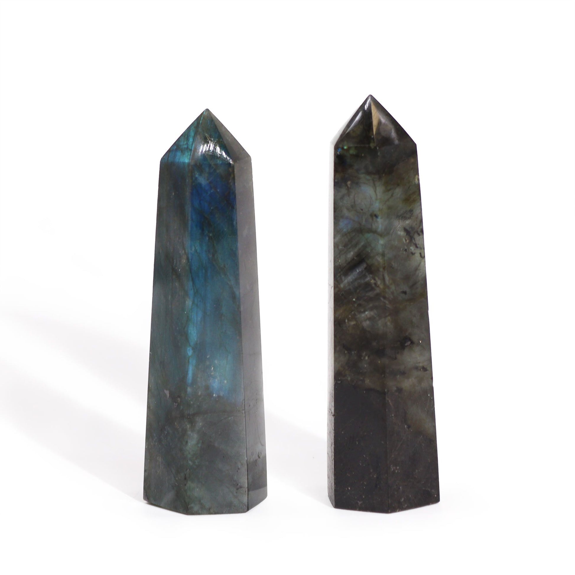 Sleek, polished Madagascar Labradorite crystal point showing shimmering iridescent blue and green flashes.