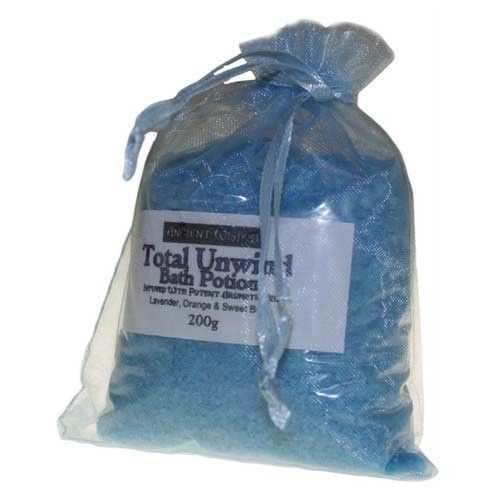 Clear bag containing aromatic purple bath salts with dried botanicals for a relaxing soak.