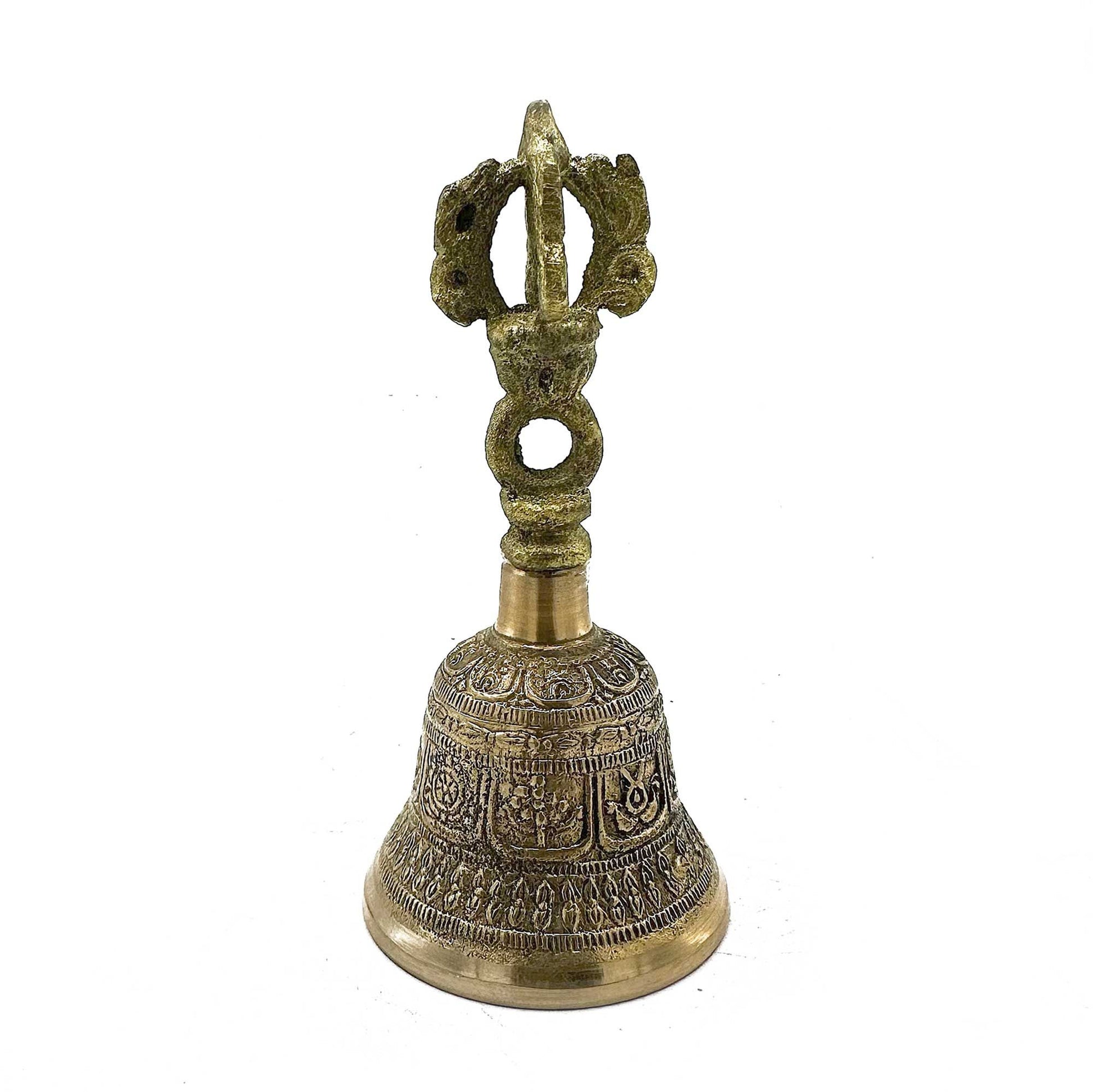 Handcrafted circular Tibetan Tingsha bells connected by a leather strap, featuring traditional embossed designs.