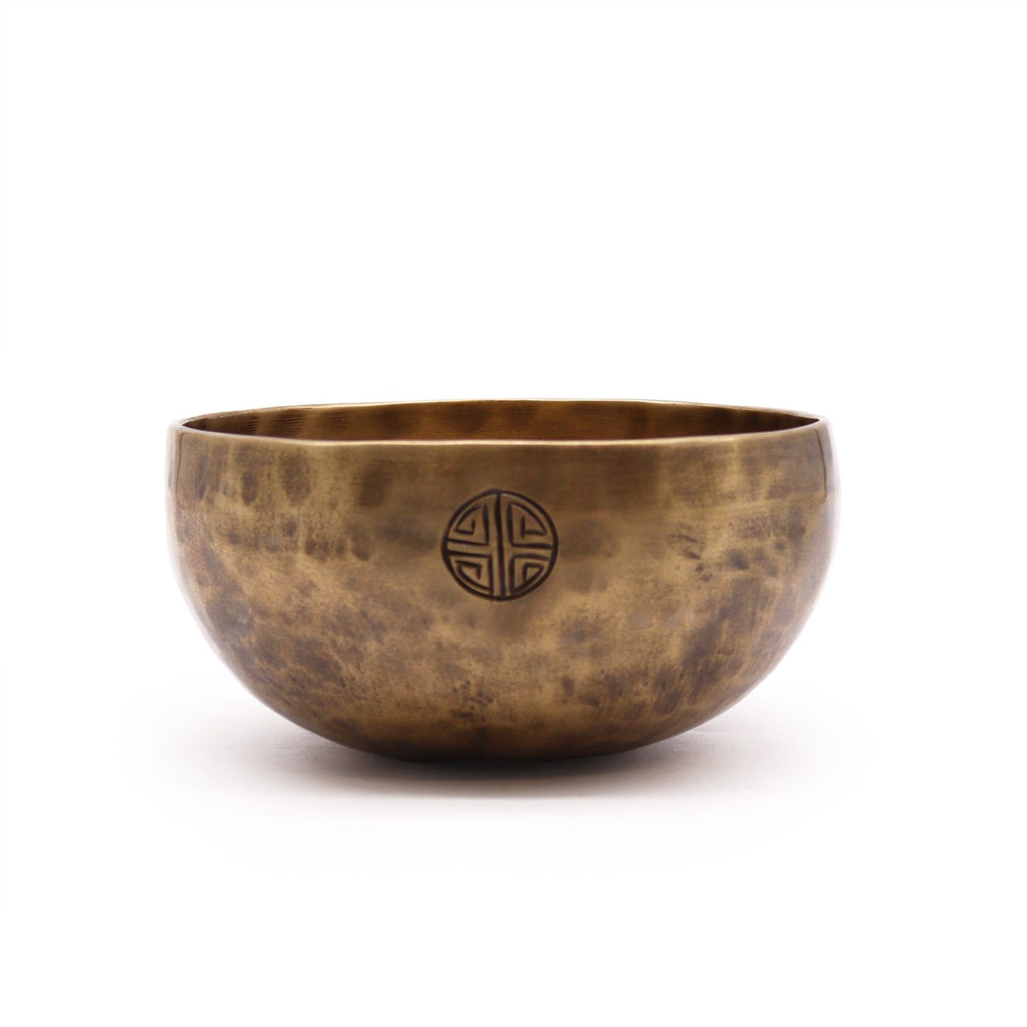 Hand-hammered bronze Tibetan singing bowl with a textured moon-like surface and traditional round shape.
