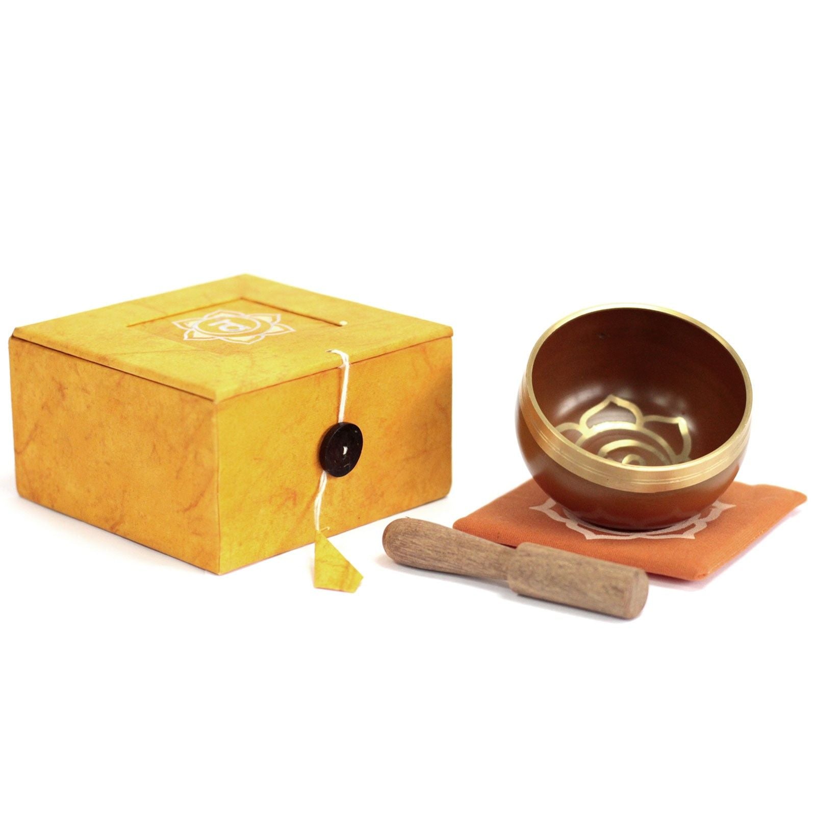 Handcrafted orange Tibetan singing bowl with sacral chakra symbols and a wooden striker.