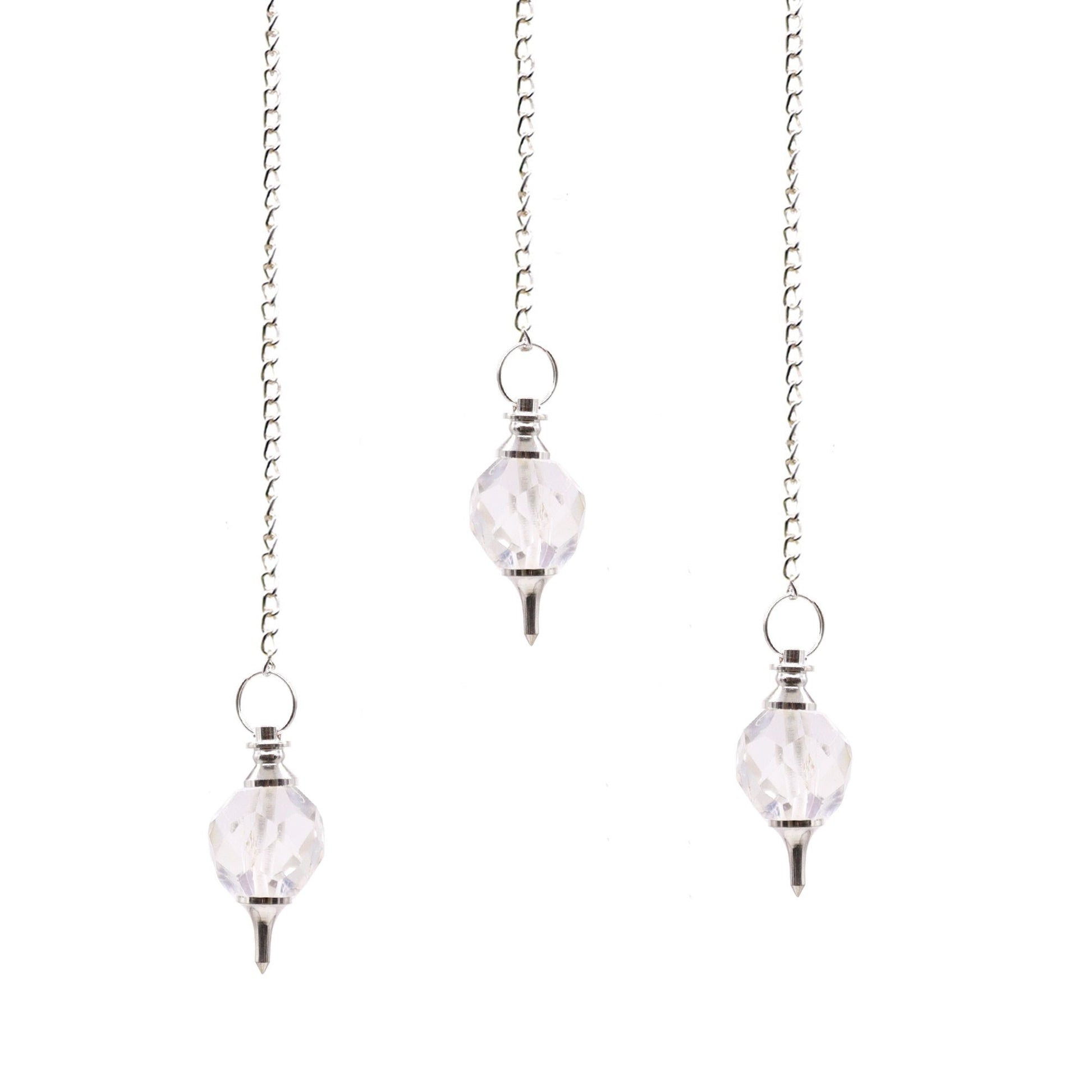 Clear faceted rock quartz crystal pendulum suspended from a delicate silver chain.