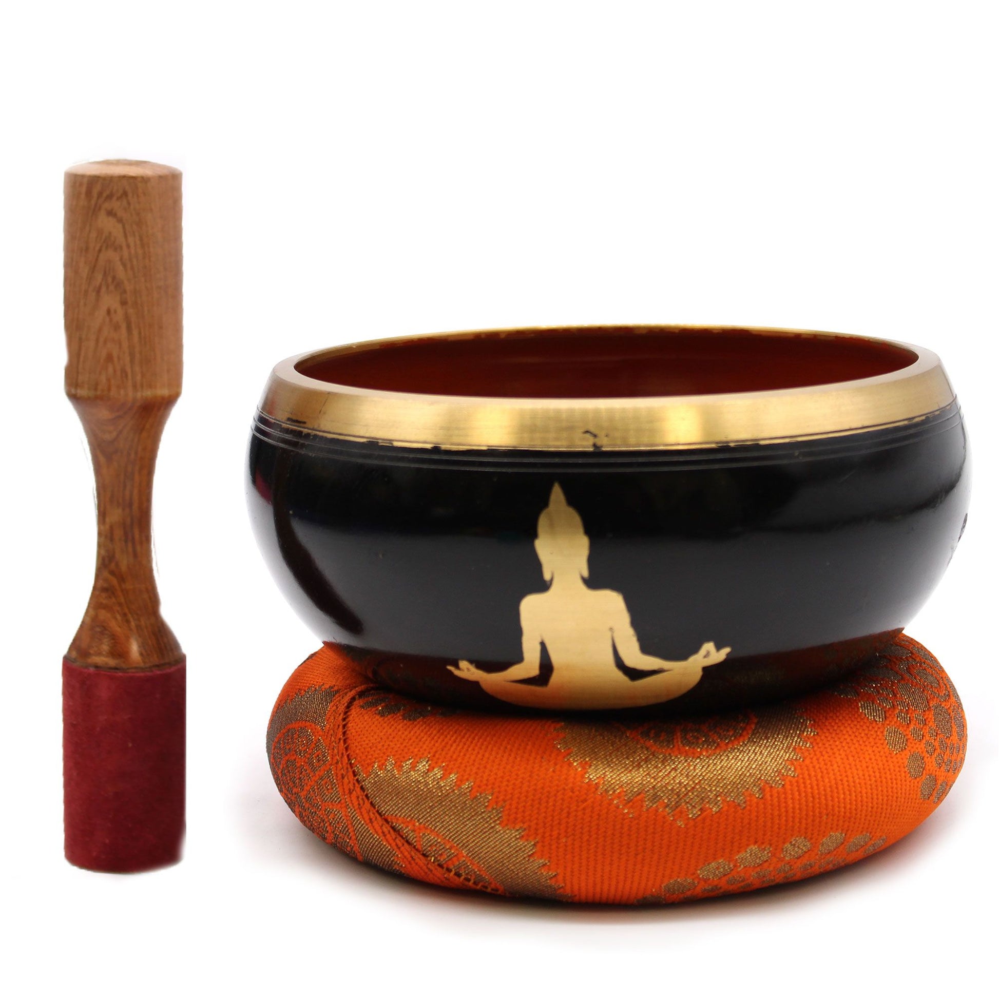 Large black and orange Tibetan singing bowl with intricate Buddha engravings and matching cushion.