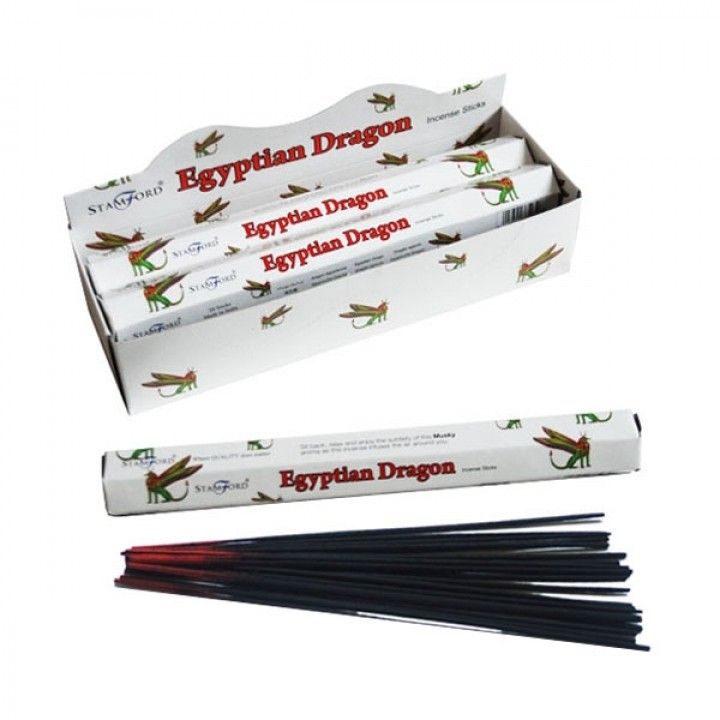 Hexagonal pack of premium incense sticks with an Egyptian dragon theme and a lit incense stick releasing fragrant smoke.