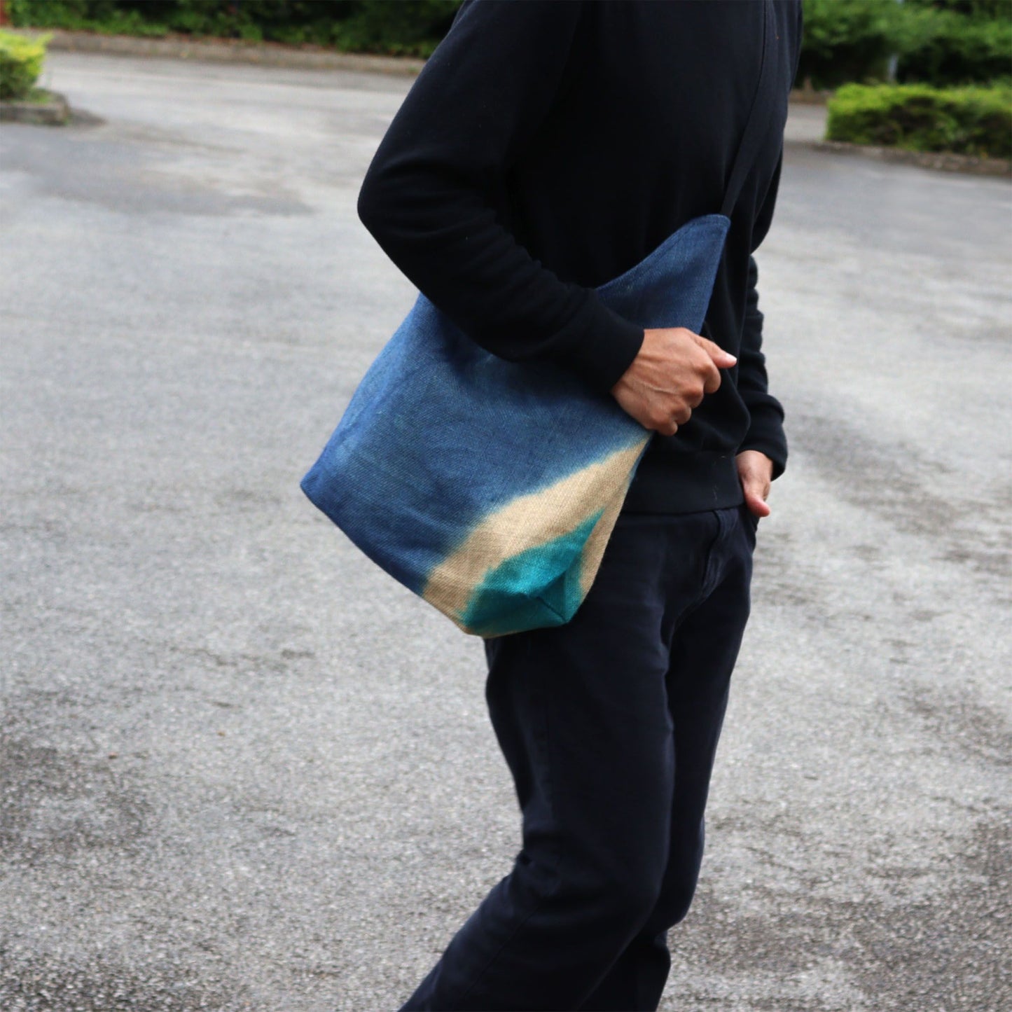 Denim blue textured shoulder tote bag crafted from a soft blend of jute and cotton with a minimalist aesthetic.