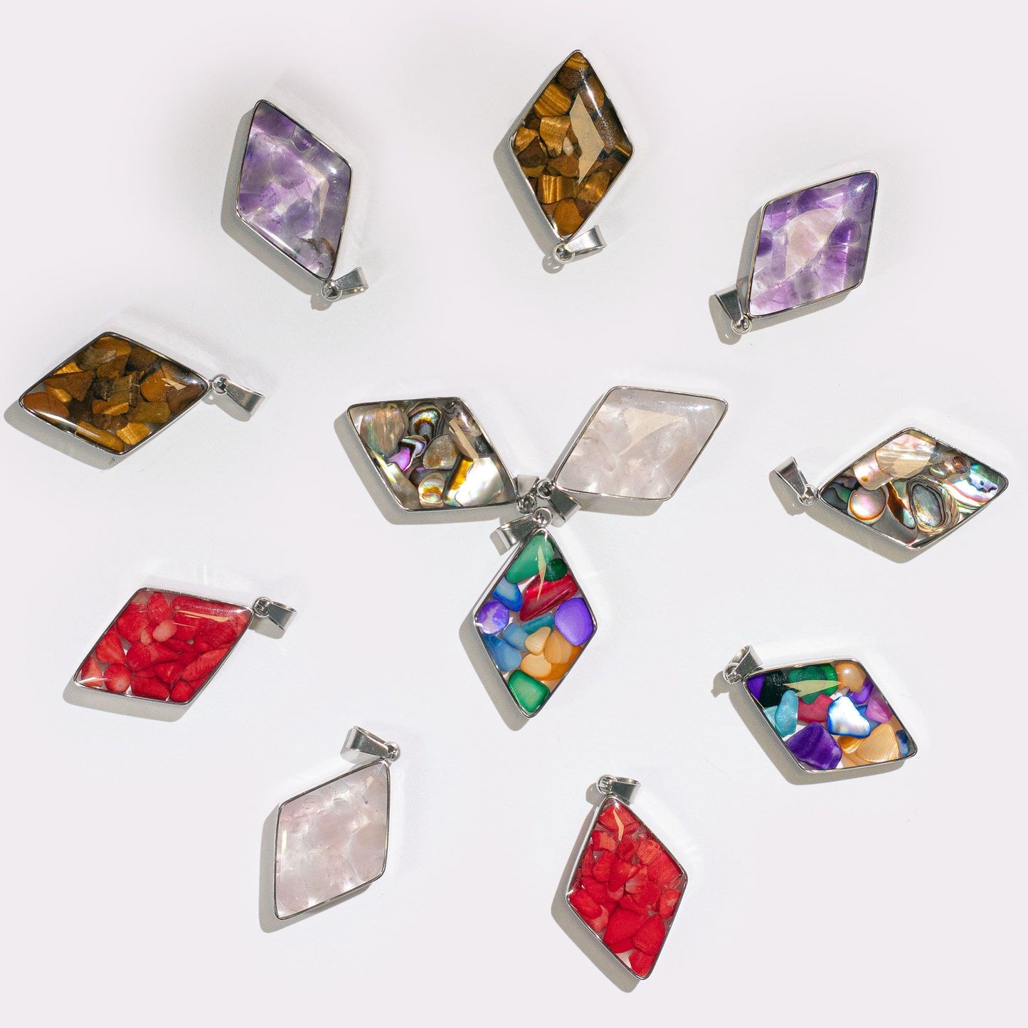 Thirteen diamond-shaped steel-cased pendants filled with various colourful gemstone chips and natural shells.