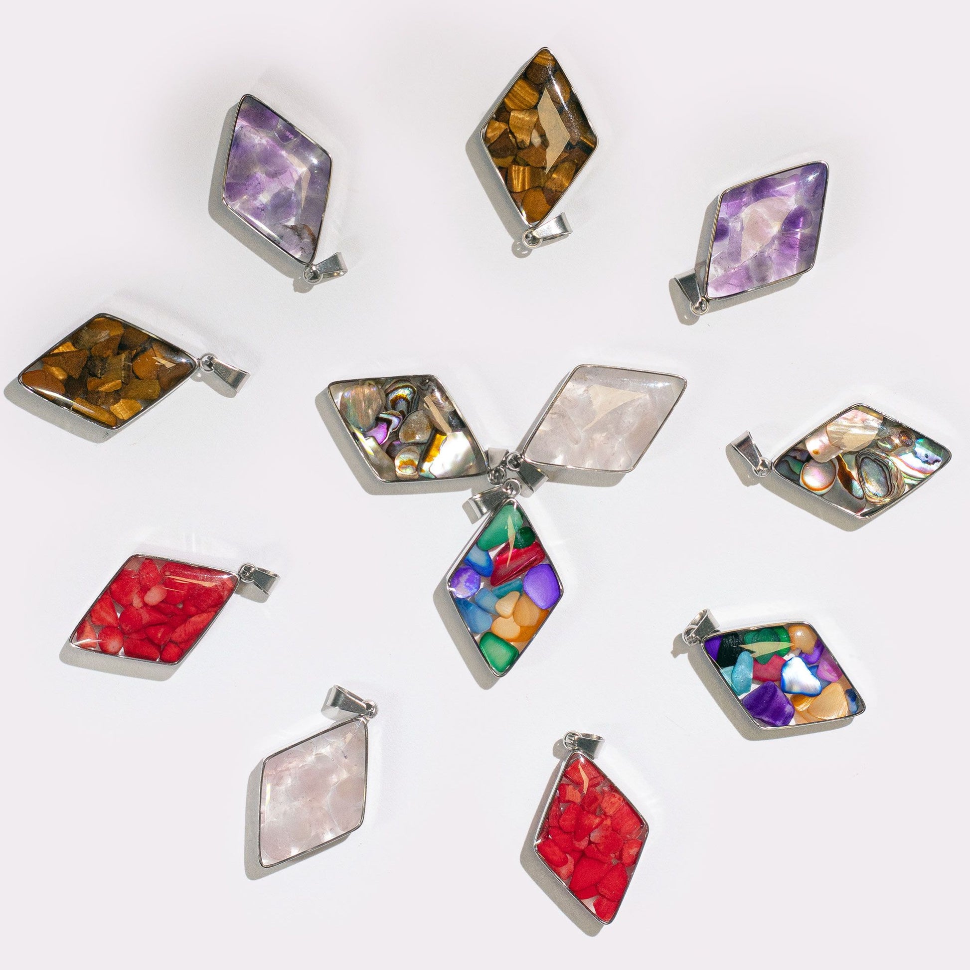 Thirteen diamond-shaped steel-cased pendants filled with various colourful gemstone chips and natural shells.